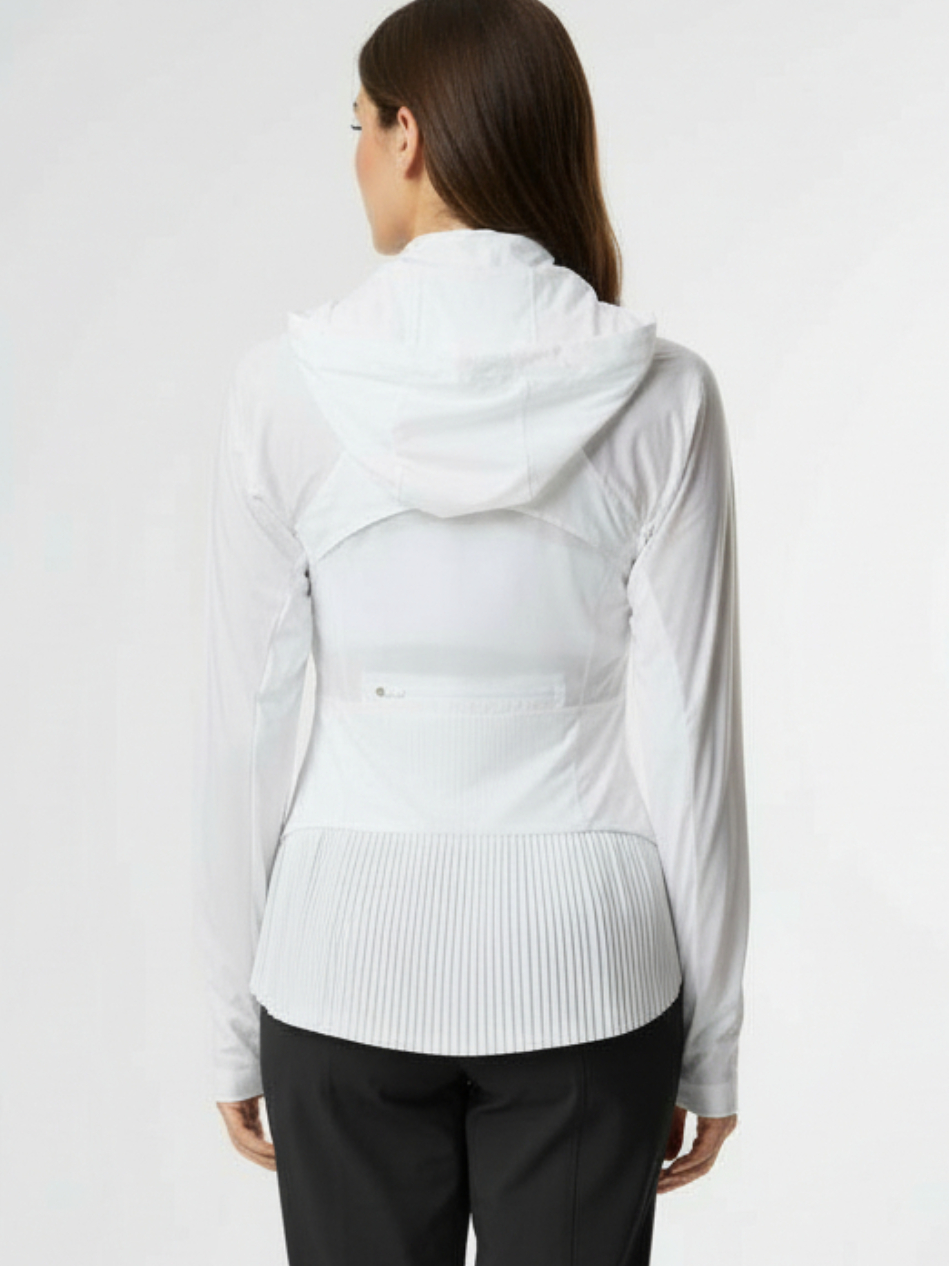 Woman wearing a white long-sleeve athletic jacket with pleats on back