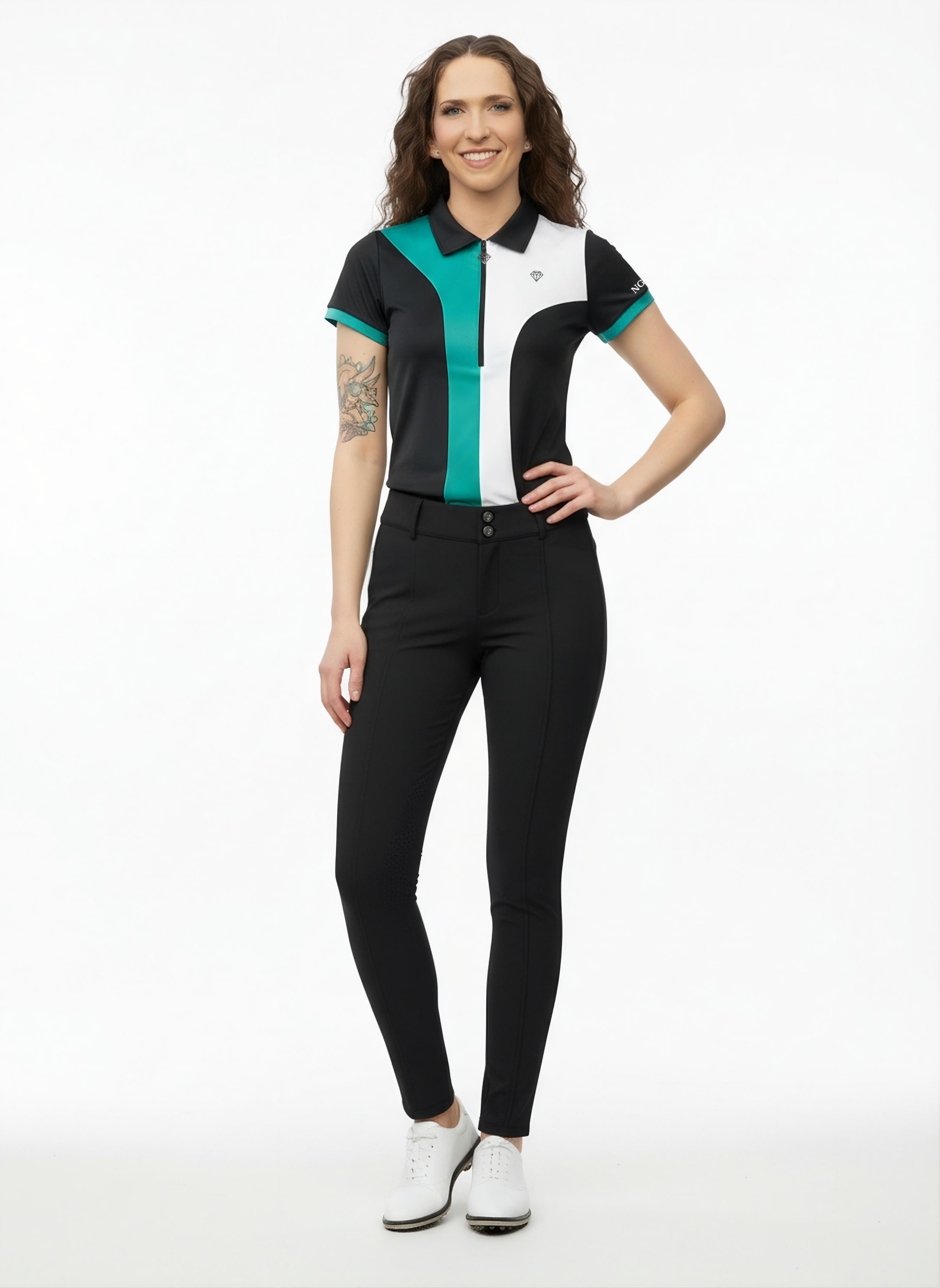 Woman wearing Par-Tee Polo - a black, white & green polo shirt and black Tee'd Up Trousers on a white background