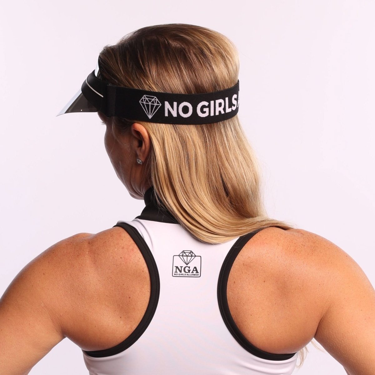 WOMAN wearing a SHINY SILVER MIRROR visor with 'NO GIRLS ALLOWED' text and a white tank top with 'NGA' logo.