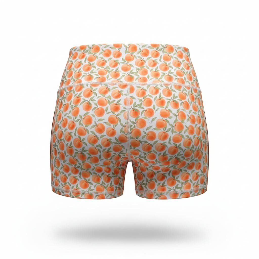 NGA - No Girls Allowed high-waisted compression shorts in a white and orange peach print pattern